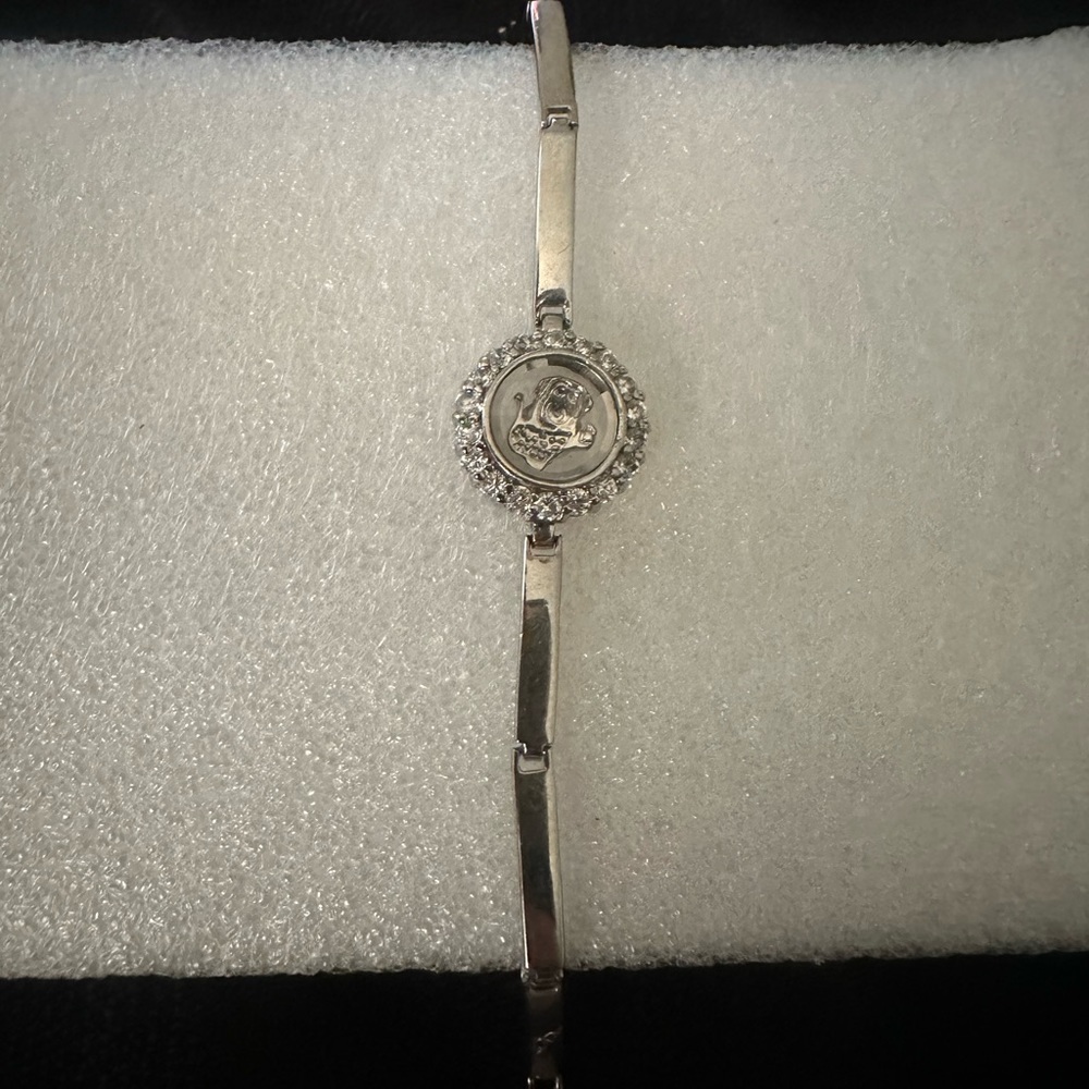 Coach bracelet watch silver center piece is horse & carriage